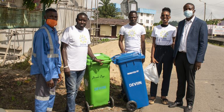 DEVIIN Team together with the Buea Council Representative Installing Trash Cans at Federal Quarter, Buea